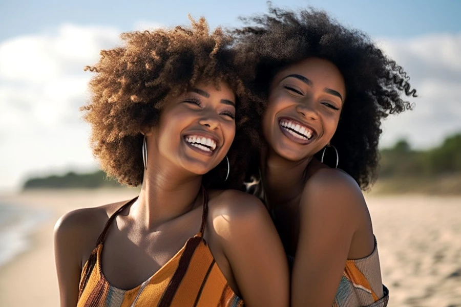 Informed Skincare Choices Image: A portrait photograph of two confident women on the beach on a a sunny day.